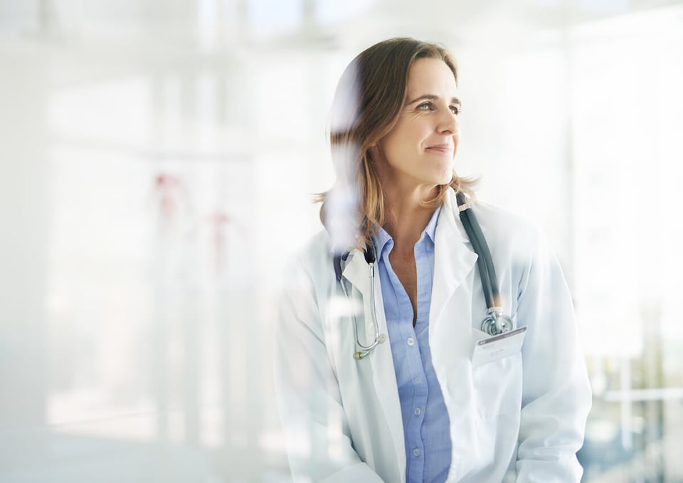 female doctor looking through a window